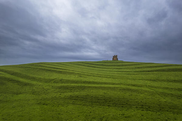Elevated view of St Catherine's Chapel in green meadows against the cloudy sky, Abbotsbury, Jurassic Coast, UNESCO World Heritage Site, Dorset, England, United Kingdom