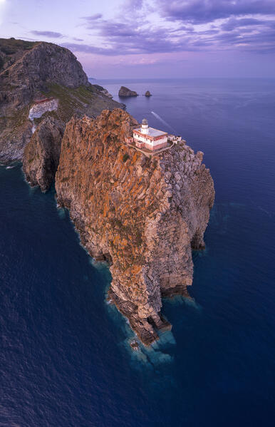 Panoramic aerial view of the lighthouse on top of a rocky cliff at dusk, Punta della Guardia, Ponza island, Pontine archipelago, Latina province, Latium region, Tyrrhenian Sea, Italy, Europe