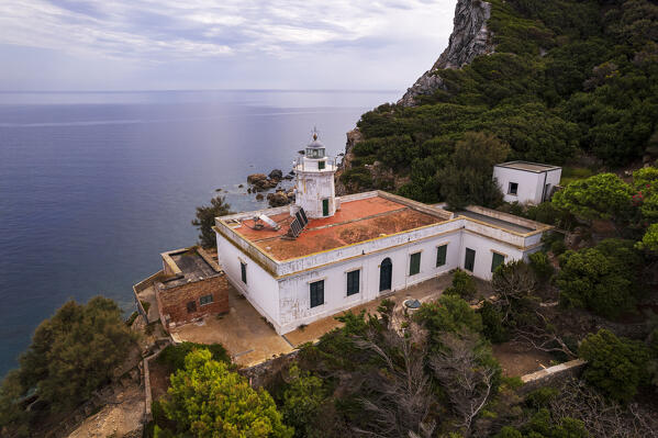 Zannone lighthouse of Capo Negro on top of a rocky island surrounded by mediterranean vegetation, aerial view, Zannone island, Ponza municipality, Pontine islands, Tyrrhenian Sea, Circeo National Park, Latina province, Latium, Italy