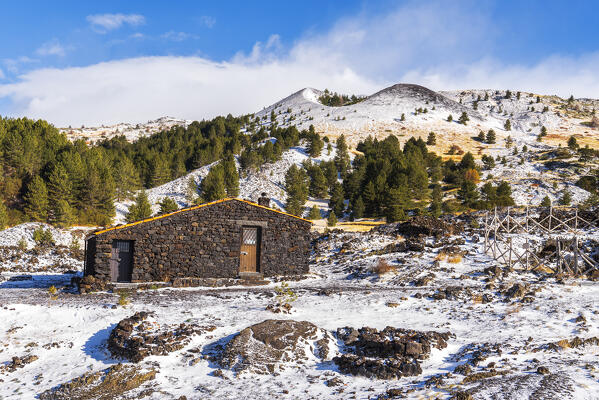 Winter view of Santa Barbara mountain hut made of volcanic rocks surrounded by craters and lava field covered with snow, day light, Piano Vetore, Regalna, Catania province, UNESCO World heritage Site, Sicily, Mediterranean Sea, Southern Italy, Italy, Southern Europe, Europe