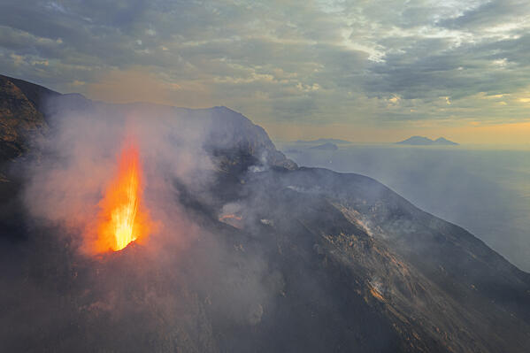 Stromboli volcano eruption seen from the drone at sunset, Stromboli island, UNESCO World Heritage Site, Aeolian Islands, Sicily, Tyrrhenian Sea, Mediterranean Sea, South of Italy, Italy, Southern Europe, Europe