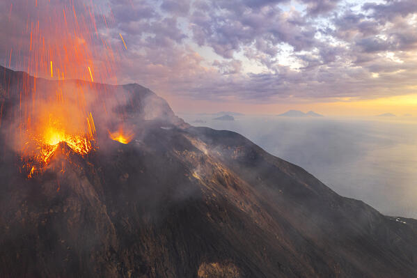 Eruption with lava fountain of Stromboli volcano seen at sunset, aerial view, Stromboli island, UNESCO World Heritage Site, Aeolian Islands, Sicily, Tyrrhenian Sea, Mediterranean Sea, South of Italy, Italy, Southern Europe, Europe
