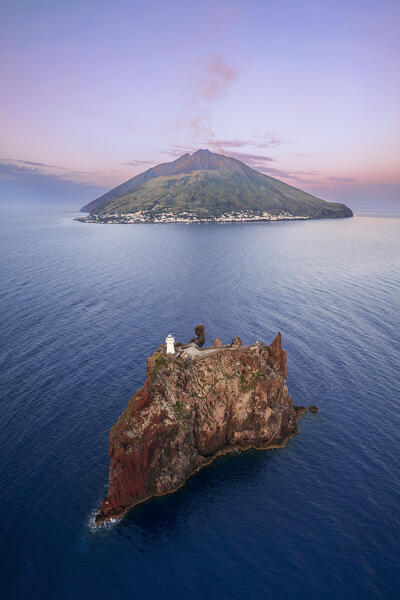 Panoramic aerial view of Stromboli volcano with the small island of Strombolicchio and the lighthouse at dusk, Stromboli island, UNESCO World Heritage Site, Aeolian Islands, Sicily, Tyrrhenian Sea, Mediterranean Sea, South of Italy, Italy, Southern Europe, Europe
