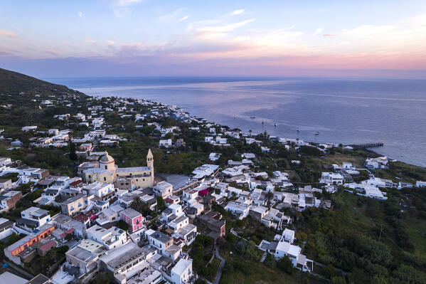 The small fishing village with white houses of Stromboli seen from above at sunrise, drone shot, Stromboli island, UNESCO World Heritage Site, Aeolian Islands, Sicily, Tyrrhenian Sea, Mediterranean Sea, South of Italy, Italy, Southern Europe, Europe
