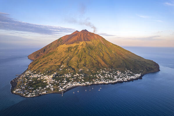 Sunset on Stromboli village with black smoke rising from the crater of the volcano, aerial view, Stromboli island, UNESCO World Heritage Site, Aeolian Islands, Sicily, Tyrrhenian Sea, Mediterranean Sea, South of Italy, Italy, Southern Europe, Europe
