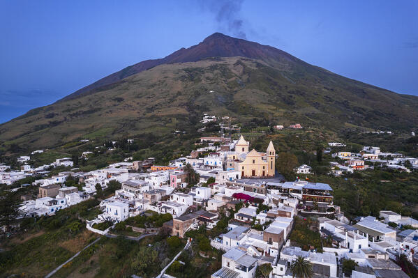 Dusk over the village of Stromboli with the smoking volcano in the background, Stromboli island, UNESCO World Heritage Site, Aeolian Islands, Sicily, Tyrrhenian Sea, Mediterranean Sea, South of Italy, Italy, Southern Europe, Europe