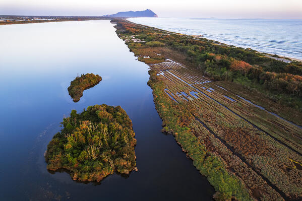 Dusk over the wild landscape of Sabaudia countryside with small islands floating on the calm water of the lake, Circeo National Park, Latina province, Latium, Central Italy, Italy, Southern Europe, Europe