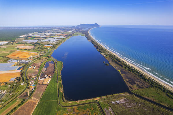 Drone view of the rural landscape with agricultural fields and a salt lake facing the shoreline, Sabaudia, Circeo National Park, Tyrrhenian Sea, Latina province, Latium, Central Italy, Italy, Southern Europe, Europe