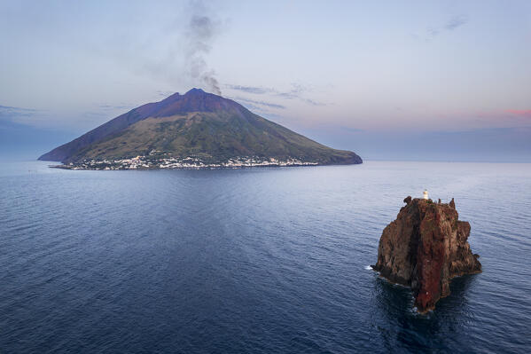 The smoking volcano and Strombolicchio island seen from the drone  at dawn, Stromboli island, UNESCO World Heritage Site, Aeolian islands, Messina province, Sicily, Tyrrhenian Sea, Mediterranean Sea, South of Italy, Italy, Europe