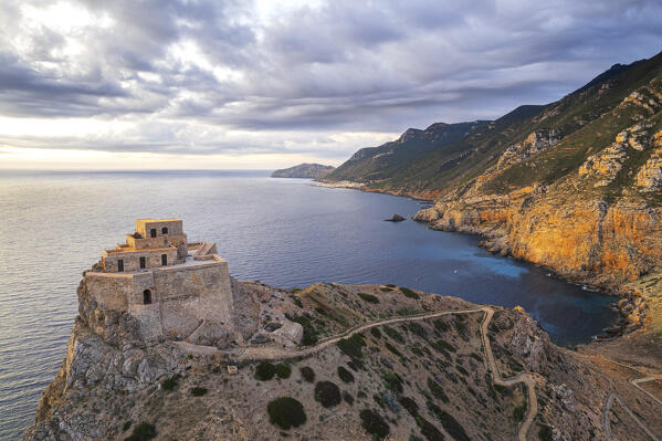 Stronghold of Punta Troia frames the rocky coast of the remote island of Marettimo at sunrise, drone view, Marettimo, Favignana municipality, Trapani, Aegadian islands, Mediterranean Sea, Sicily, Italy