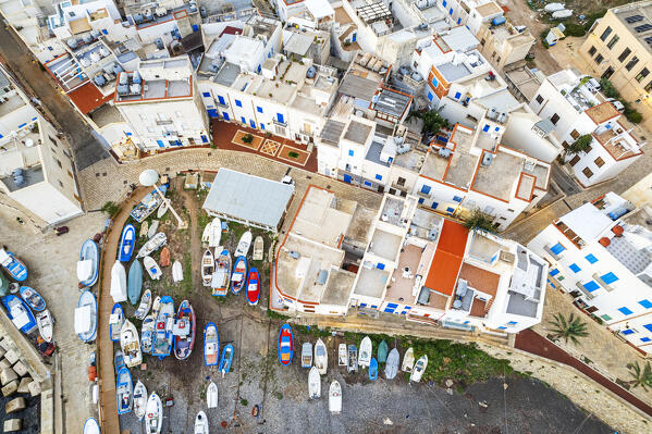 Top-down aerial view of the white village of Marettimo with boats anchored on the beach, drone view, Marettimo, Favignana municipality, Trapani, Aegadian islands, Mediterranean Sea, Sicily, Italy