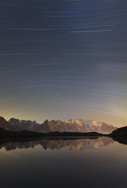Lake Chesery, Mount Blanc, France. Startrail on Mount Blanc massif, reflected in an alpine lake.
