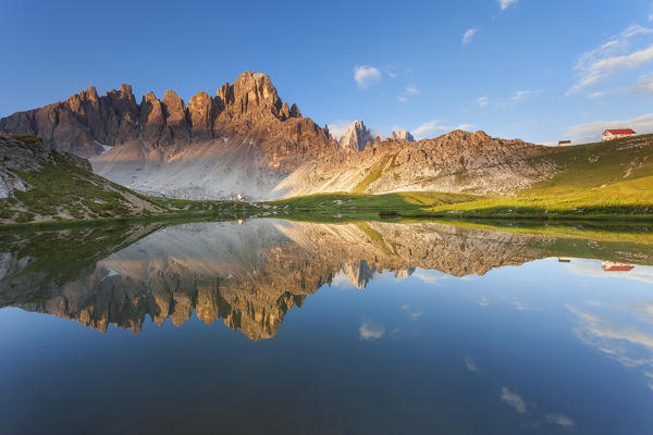 Monte Paterno, Dolomites, Italy. An alpine lake it's reflecting the first lights on a mountain.