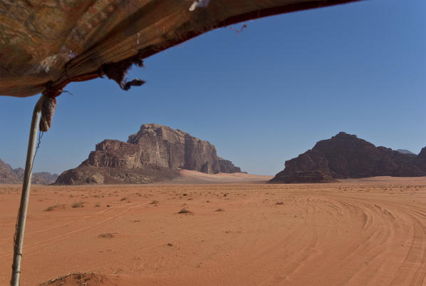 Mount Rum on the left is made up of granite rock and rises from the red sand of Wadi Rum desert, Jordan