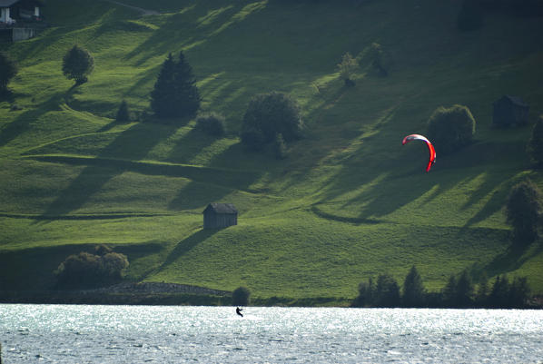 A skysurfer on Resia lake, val venosta, trentino, iltay