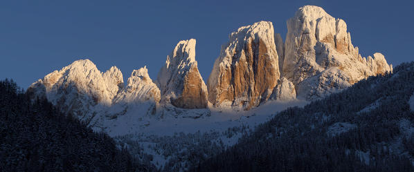 Enrosadira on Sassolungo in winter, Canazei, Val di Fassa, Province of Trento, Trentino Alto-Adige, Italy