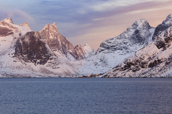 View on Kirkefjord,the surrounding mountains and the village of Rostad at sunrise from Reine, lofoten islands, nordland, norway, europe