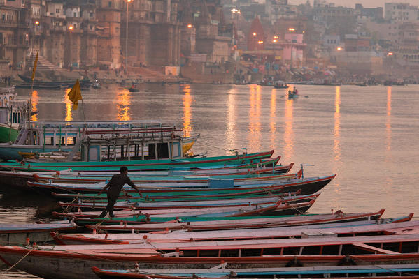 Boat at the banks of Gange river, in the colours of sunrise. (Varanasi, India)