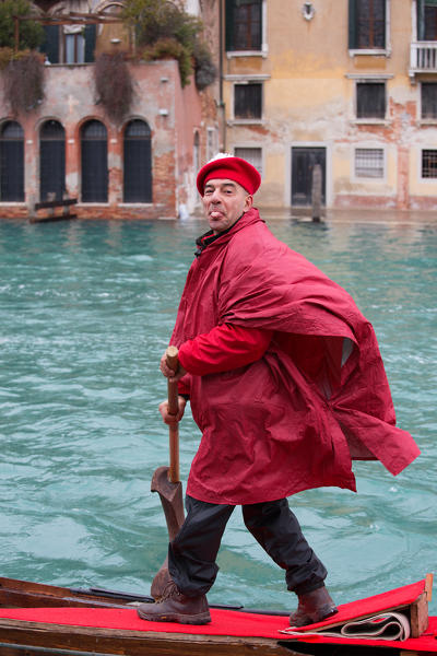 Europe,Italy,Veneto,Venice
Gondolier in mask while paddling along the canal of Venice