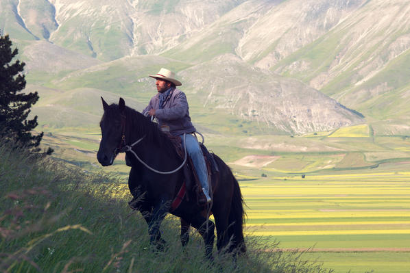 Europe, Italy,Umbria,Perugia district, Castelluccio of Norcia 
Boy riding 