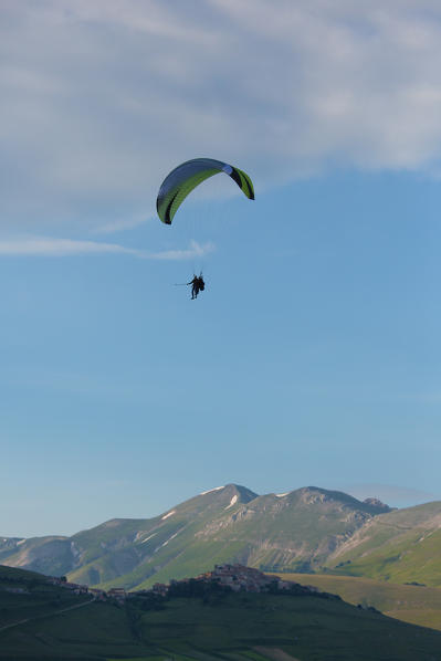 Europe, Italy,Umbria,Perugia district.
Paraglider flying over Castelluccio of Norcia.