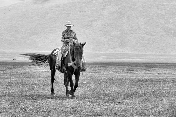 Europe,Italy,Umbria,Perugia district,Castelluccio of Norcia. Woman riding