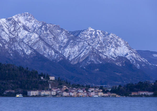 Blue hour at dawn over lake como ,view of Cadenabbia in Background Bellagio and Grigne covered by snow, 