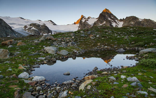 A little alpine lake it's reflecting the first morning lights on Ruitor's glacier and Grand Assaly.