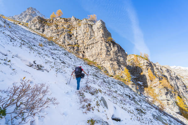 Hiker on first snow, Alpe Veglia, Veglia Devero Natural Park, Ossola,  province of Verbano Cusio Ossola, Piedmont, Italian alps, Italy