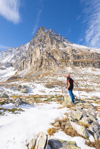 Hiker and east face of Monte Leone, Alpe Veglia, Veglia Devero Natural Park, Ossola,  province of Verbano Cusio Ossola, Piedmont, Italian alps, Italy