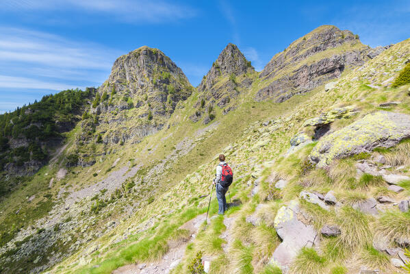 Hiker under Tre Pizzi, Val Brembana, Alpi Orobie, province of Bergamo, Lombardy, Italian alps, Italy