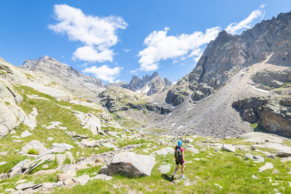 Hiker in the Vallone di Noaschetta, Valle dell Orco, Gran Paradiso National Park, Province of Turin, italian alps, Piedmont, Italy
