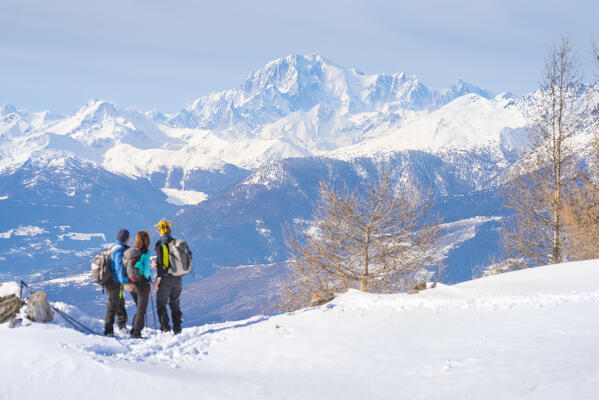 Snowshoers in front of Mont Blanc, Testa Comagna, Emarese, Aosta Valley, Italy