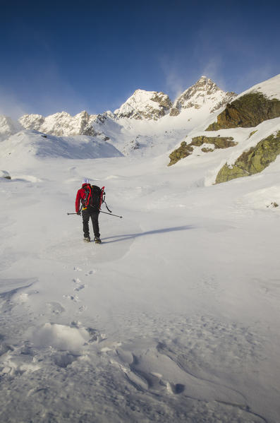 Alpinist advance on the snow (Soana valley, Gran Paradiso National Park, Piedmont)