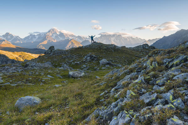 Alpinist in front of Mont Blanc massif, La Thuile, Aosta Valley, Italy, Italian alps