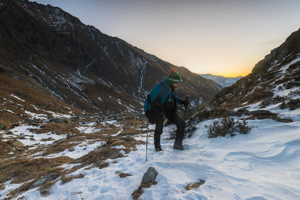 Alpinist climbing at dawn, Valle Soana, Gran Paradiso National Park, Piedmont, Italy, Italian alps