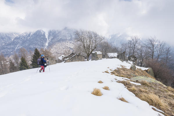 Hiker near the abandoned village of Andorina, Valle Soana, Gran Paradiso National Park, Piedmont, Italian alps, Italy