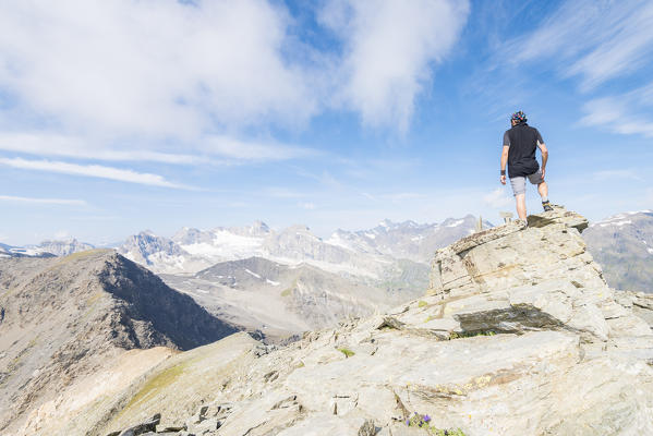 Hiker on a ridge, Valle dell'Orco, Gran Paradiso National Park, Piedmont, Italian alps, Italy