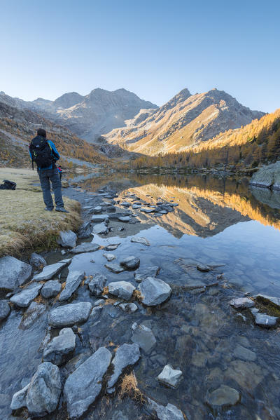 Photographer at Arpy Lake, Arpy valley, Valdigne, Aosta Valley, Italian alps, Italy
