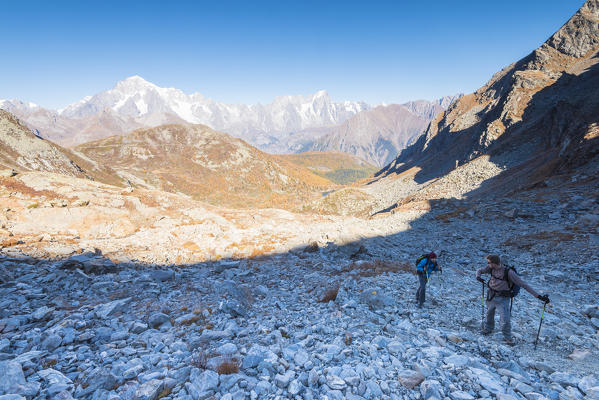 Hikers in high Arpy Valley, with Mont Blanc massif in the background, Valdigne, Aosta Valley, Italian alps, Italy