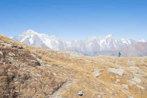Hiker with Mont Blanc massif in the background, Arpy Valley, Valdigne, Aosta Valley, Italian alps, Italy