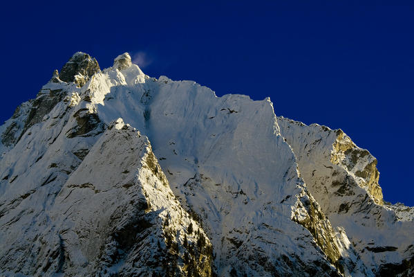 A steep rock wall in winter conditions, Cima del Largo, Valbregaglia, Graubunden, Switzerland
