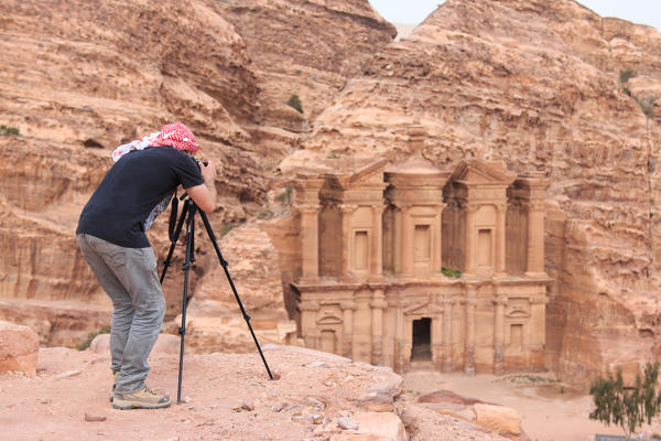 Photographer taking a picture of an ancient temple in Petra, Jordan