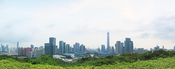 Shenzhen cityscape at sunset with the Civic Center and the Ping An IFC on foreground, China