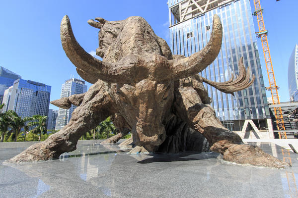 Stock market building in Shenzhen, one of the three stock markets in China, with the copper bull statue on foreground. The others two Stock Markets of China are in Hong Kong and Shanghai.