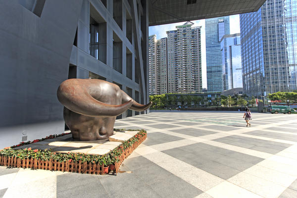 Stock market building in Shenzhen, one of the three stock markets in China, with the copper bull statue on foreground. The others two Stock Markets of China are in Hong Kong and Shanghai.