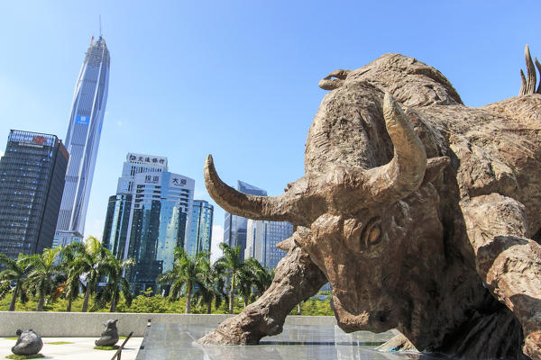 Stock market building in Shenzhen, one of the three stock markets in China, with the copper bull statue on foreground. The others two Stock Markets of China are in Hong Kong and Shanghai.