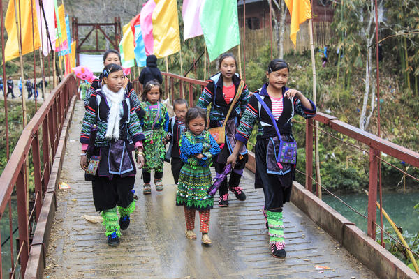 Aboriginal people of the mountains of Sapa, in north Vietnam, dressed with their traditional attire and walking in their village