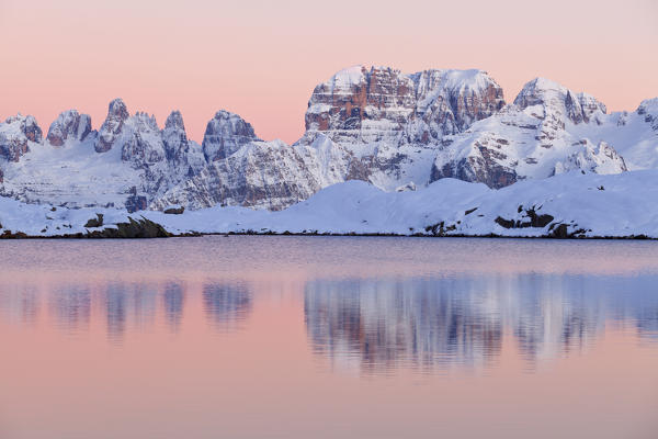 Nero lake, Adamello Brenta natural park, Trentino Alto Adige, Italy. The Brenta Dolomites in winter are reflected in the waters of Black Lake at sunset.