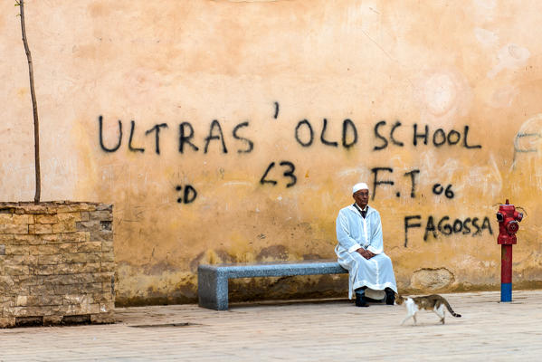 Fes, Morocco, North Africa. An old man with white dress is relaxing.